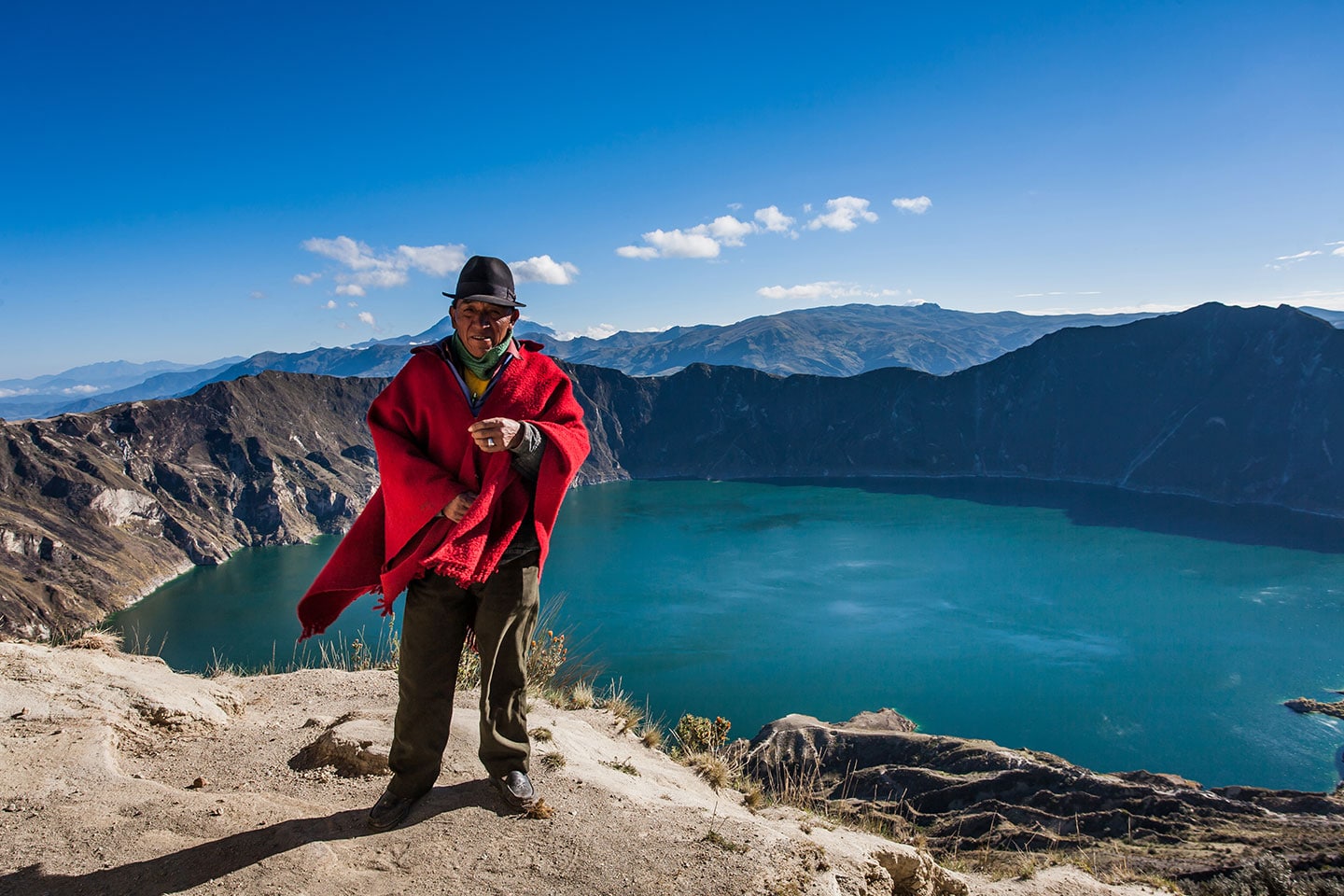A local standing on the edge Quilotoa Lake, Ecuador