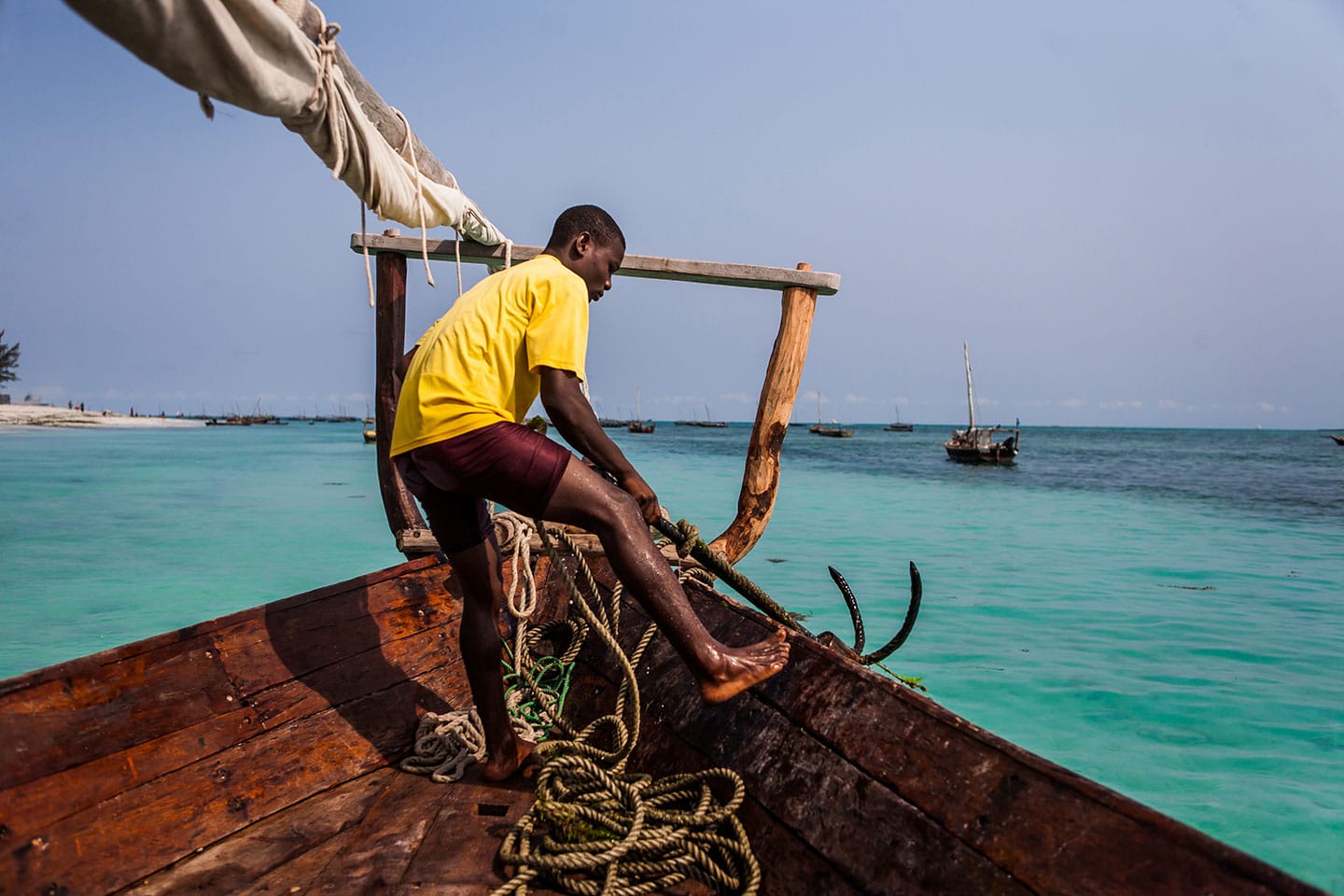 Nungwi, Zanzibar A worker on a wooden dhow boat in Zanzibar