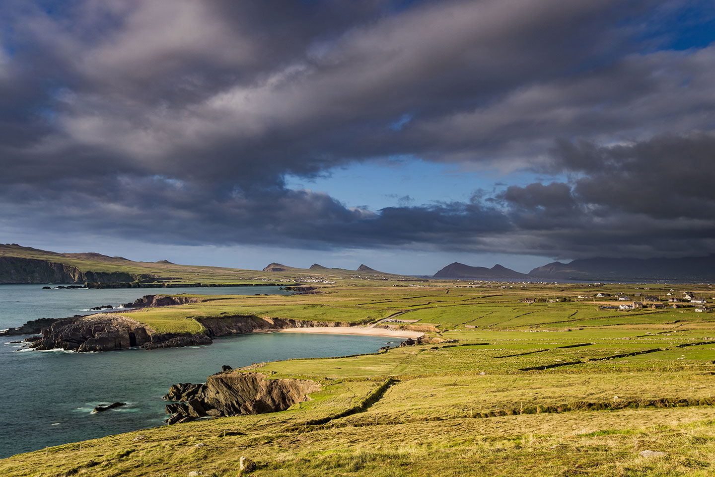 Sunset over the green fields of Dingle, Ireland