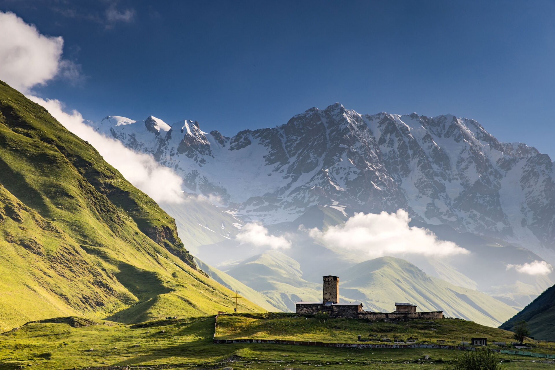 Lamaria church at sunrise with the Shkhara mountain in the back