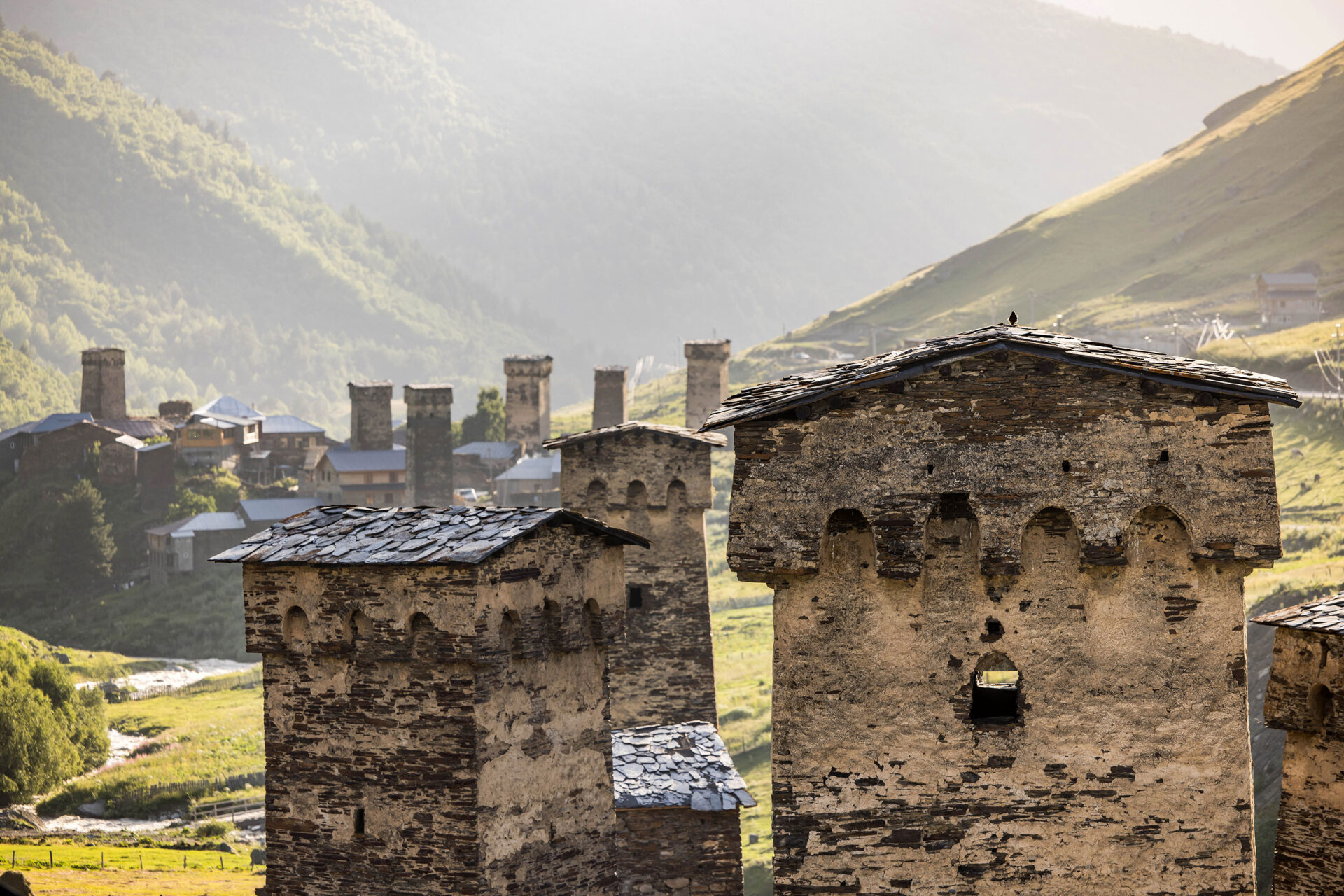 Travel photography of the Svan towers of Usghguli, Georgia at sunset