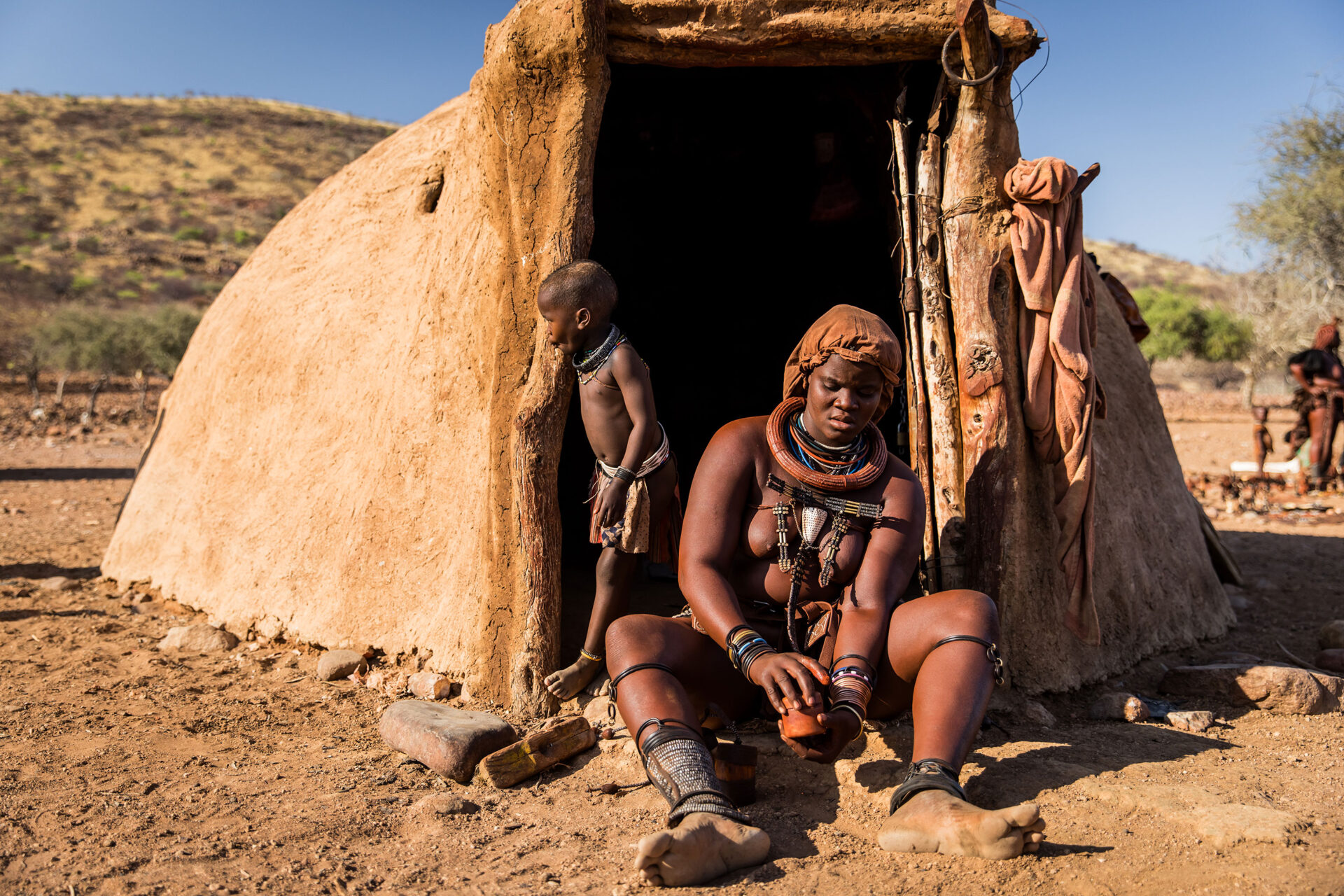Himba tribe woman with child at a village in the north of Namibia