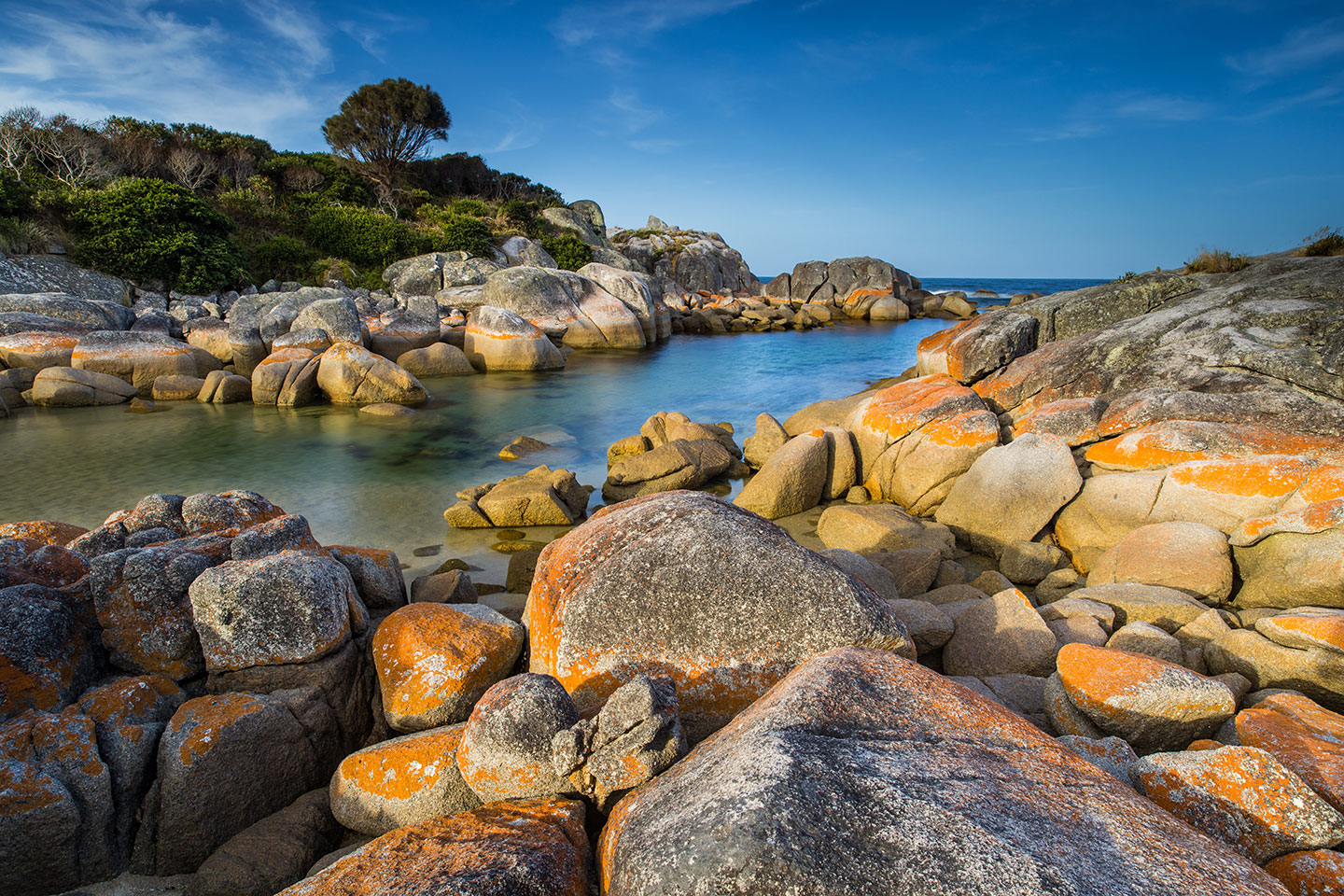 Binalong Bay, Tasmania Red lichen rocks at Binalong Bay, Tasmania